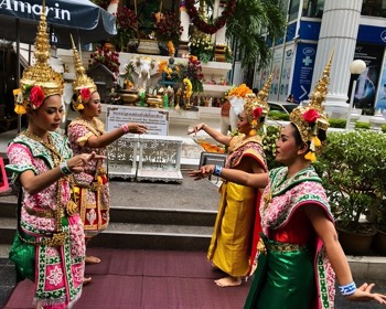  Professional Thai dancers performing a traditional dance at a Buddhist shrine in Bangkok. They are hired by individuals who are performing merit. The dancers also receive personal merit for performing the dance. 