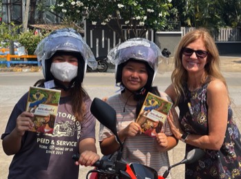 Kelly distributing helmets & Bibles in Chiang Mai