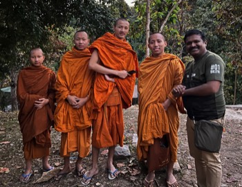 Our India friend sharing Christ's love with Buddhist monks near Chiang Mai