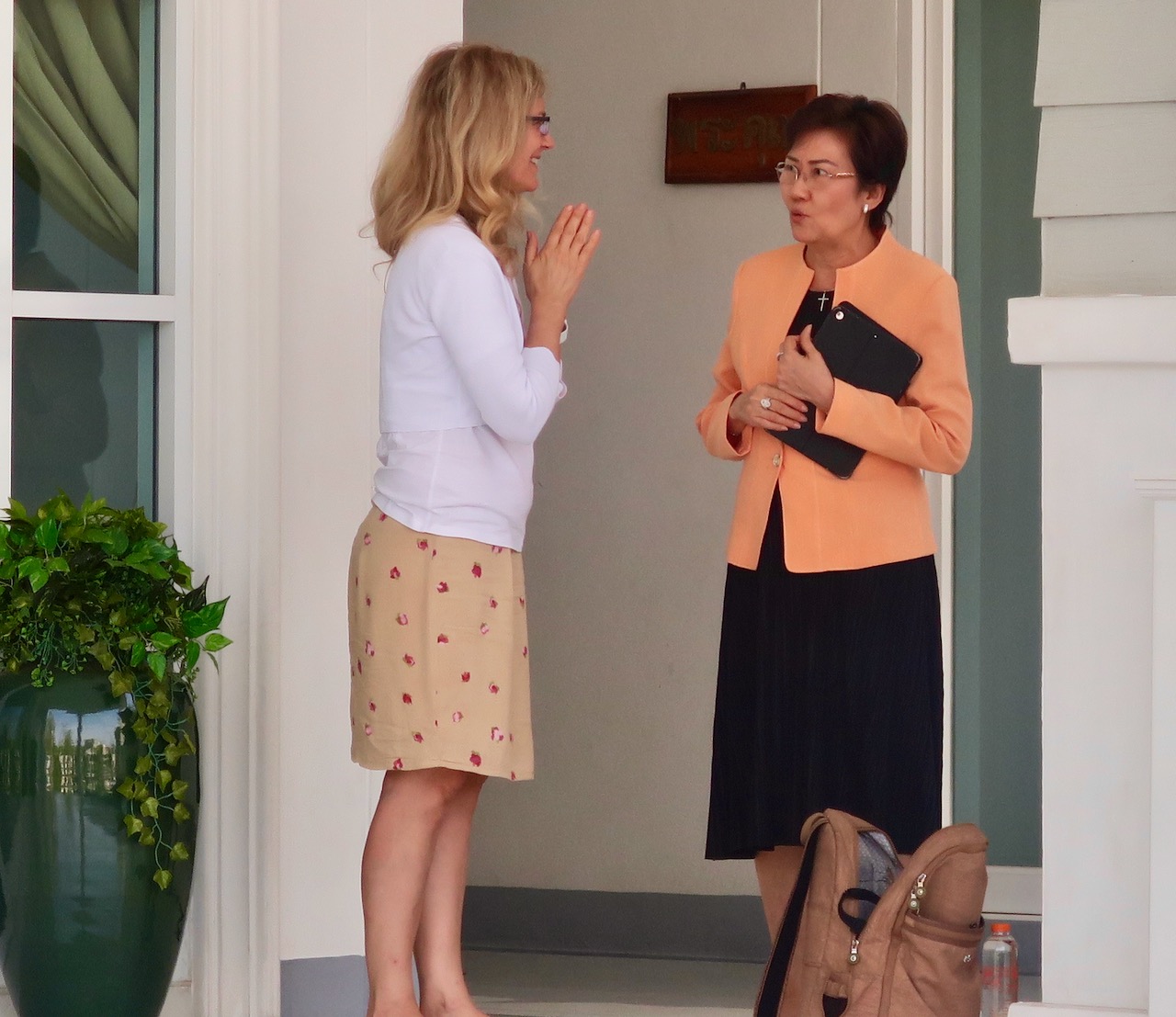  Kelly talking with Dr. Kae, a Thai leader about the Koala Love Project. 