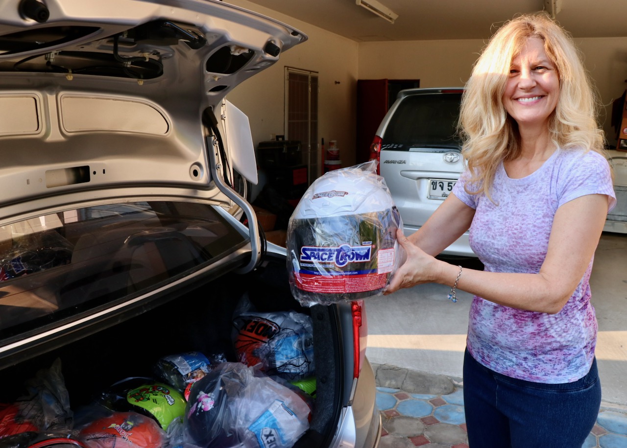  Kelly displaying a child's motorcycle helmet purchased for a Koala Outreach 