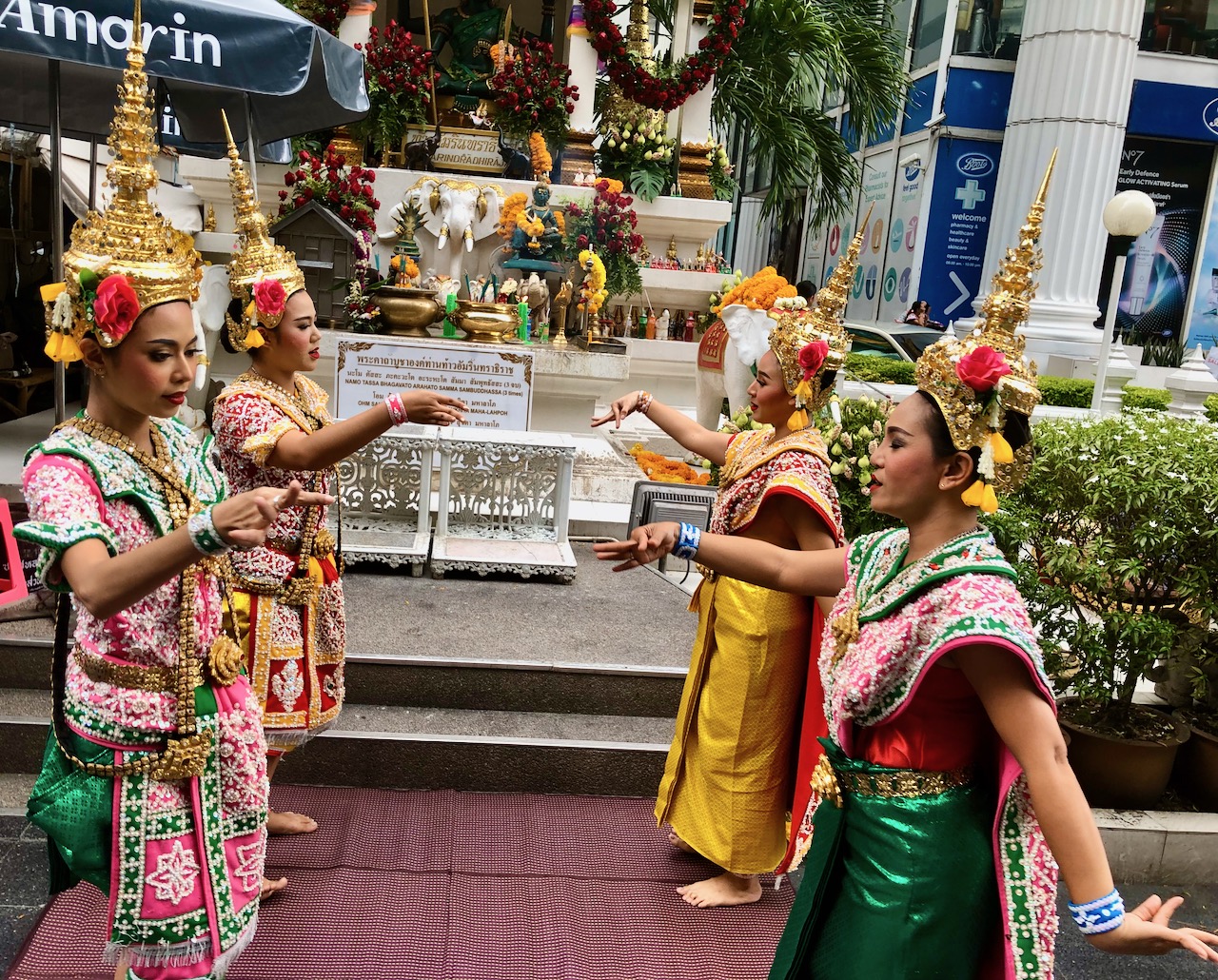  Professional Thai dancers performing a traditional dance at a Buddhist shrine in Bangkok. They are hired by individuals who are performing merit. The dancers also receive personal merit for performing the dance. 