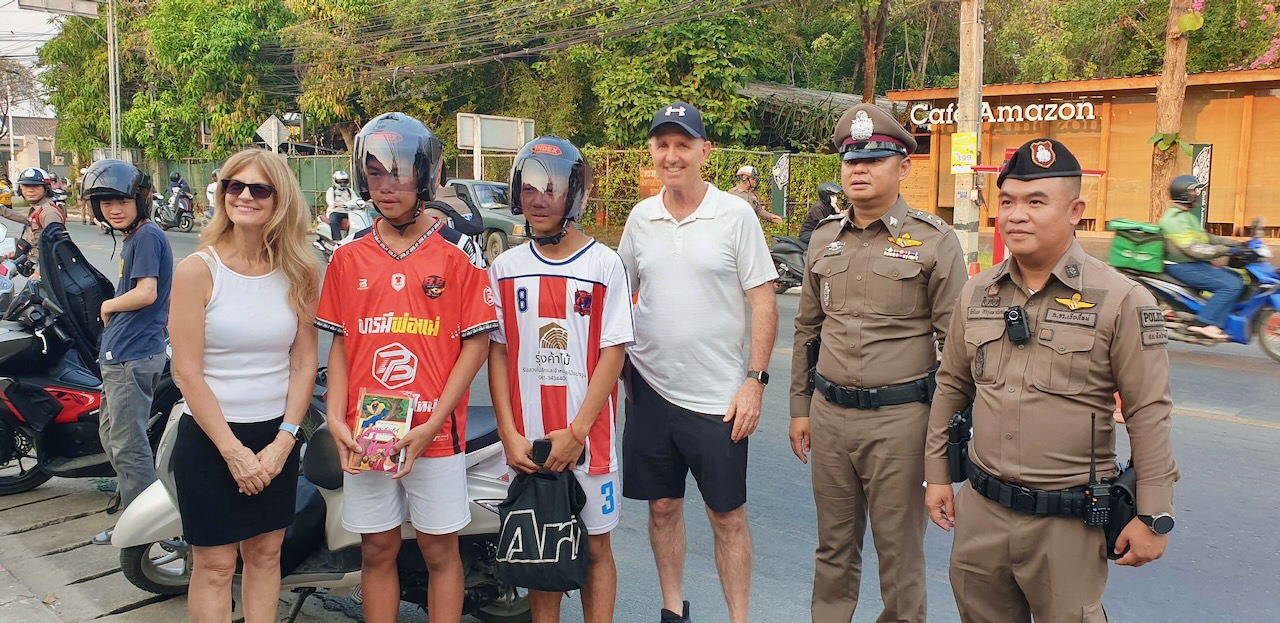 Joel & Kelly gifting helmets & Bibles at Sanpatong Police check point